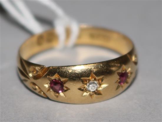 An early 20th century 18ct gold ruby and diamond gypsy set ring, size R.